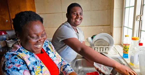 young man and mother washing dishes
