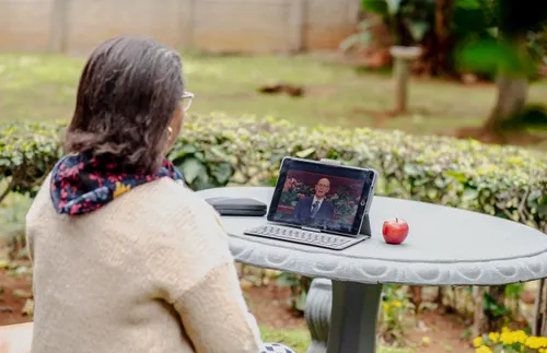 a woman watching general conference on a tablet