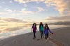 group of youth walking on beach