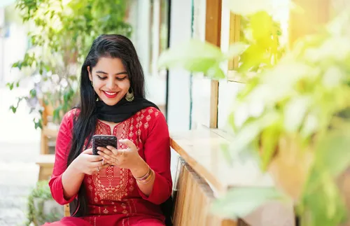 Woman smiling down at phone