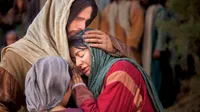 Mary and Martha embrace Jesus Christ as He stands and comforts them in His arms.