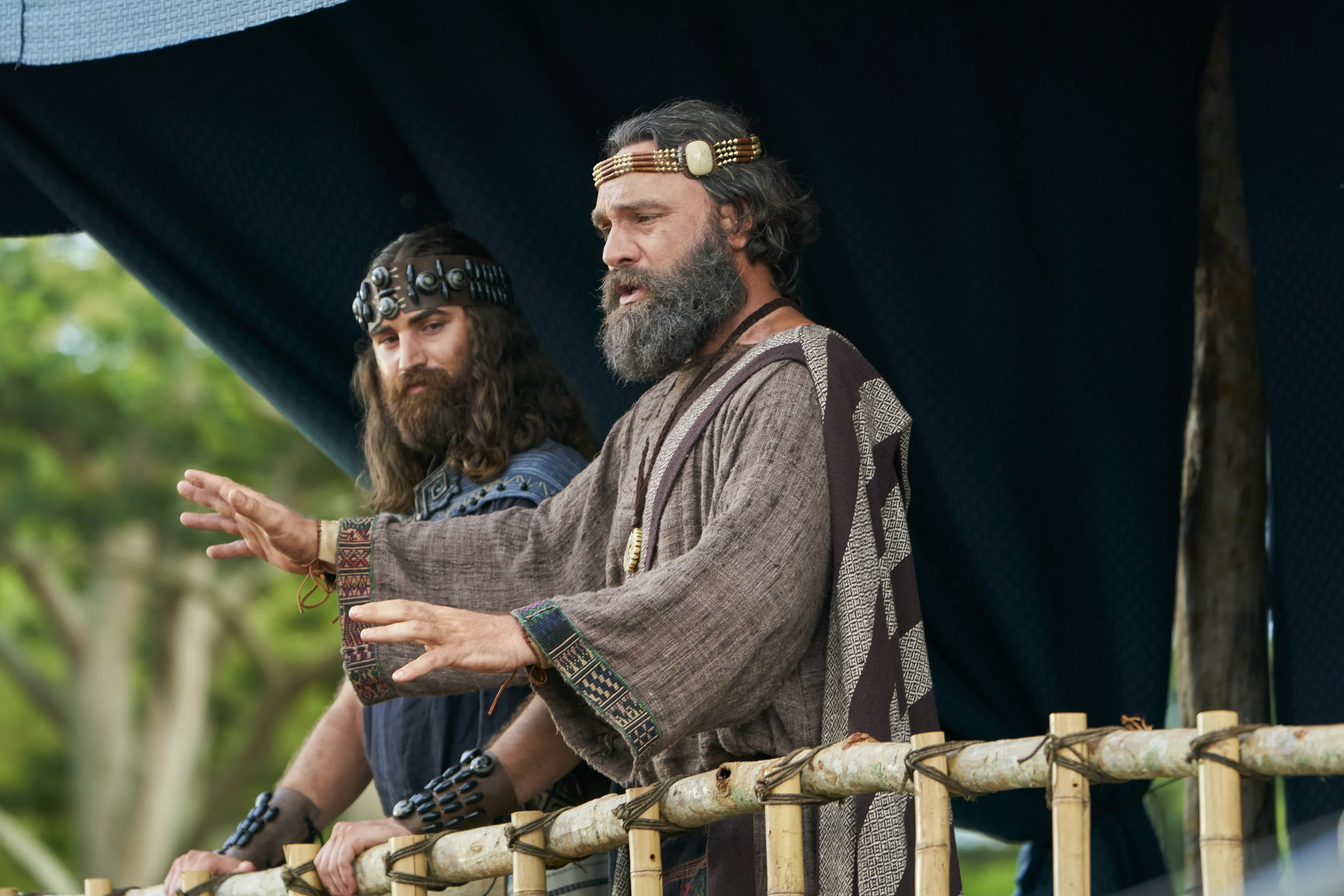 King Benjamin and Mosiah stand together on a tower talking. They are preparing to speak to the Nephites in the Land of Zarahemla.