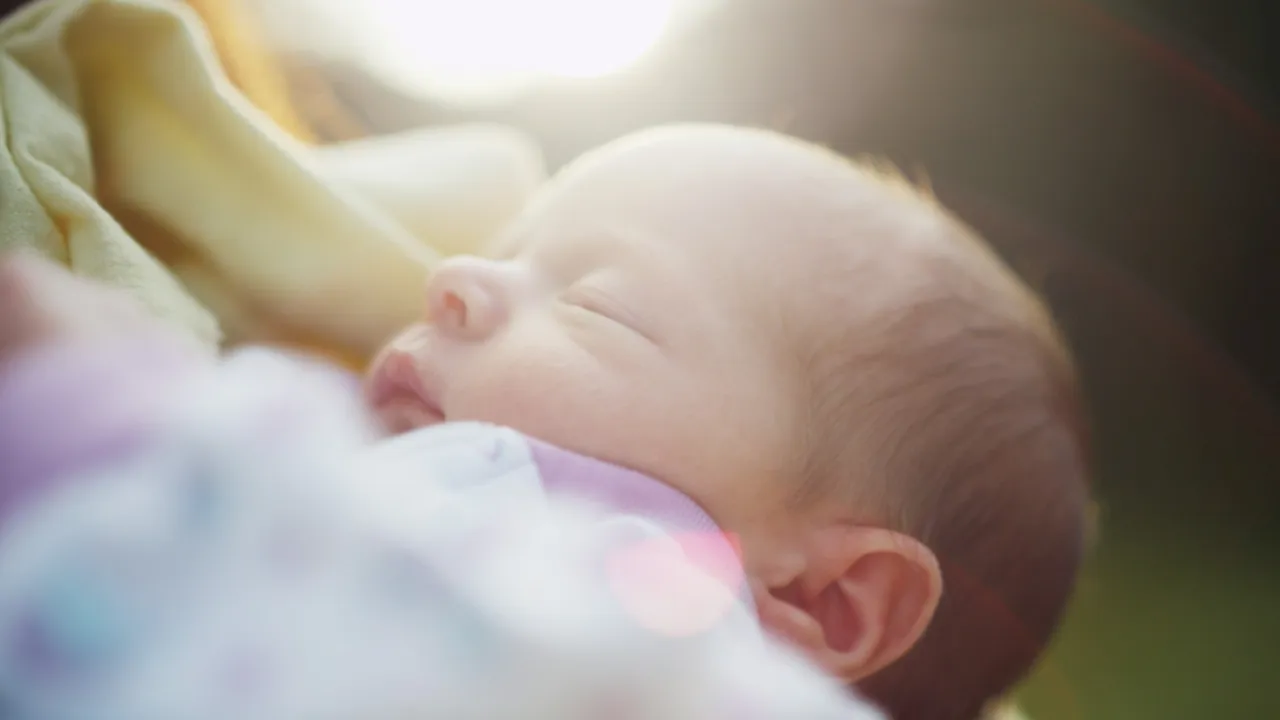 A father holds his newborn baby