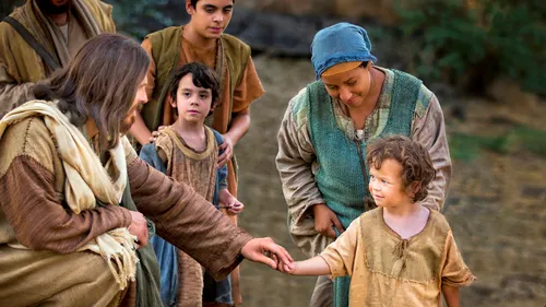 Jesus reaching out to a little child