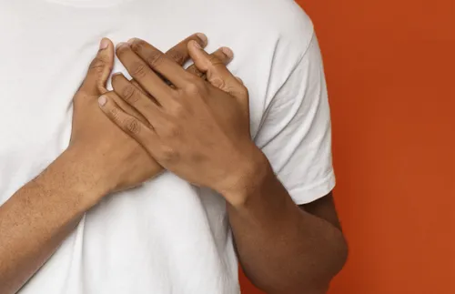 man with hands over his heart