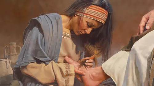 a woman washes the Savior’s feet with her tears