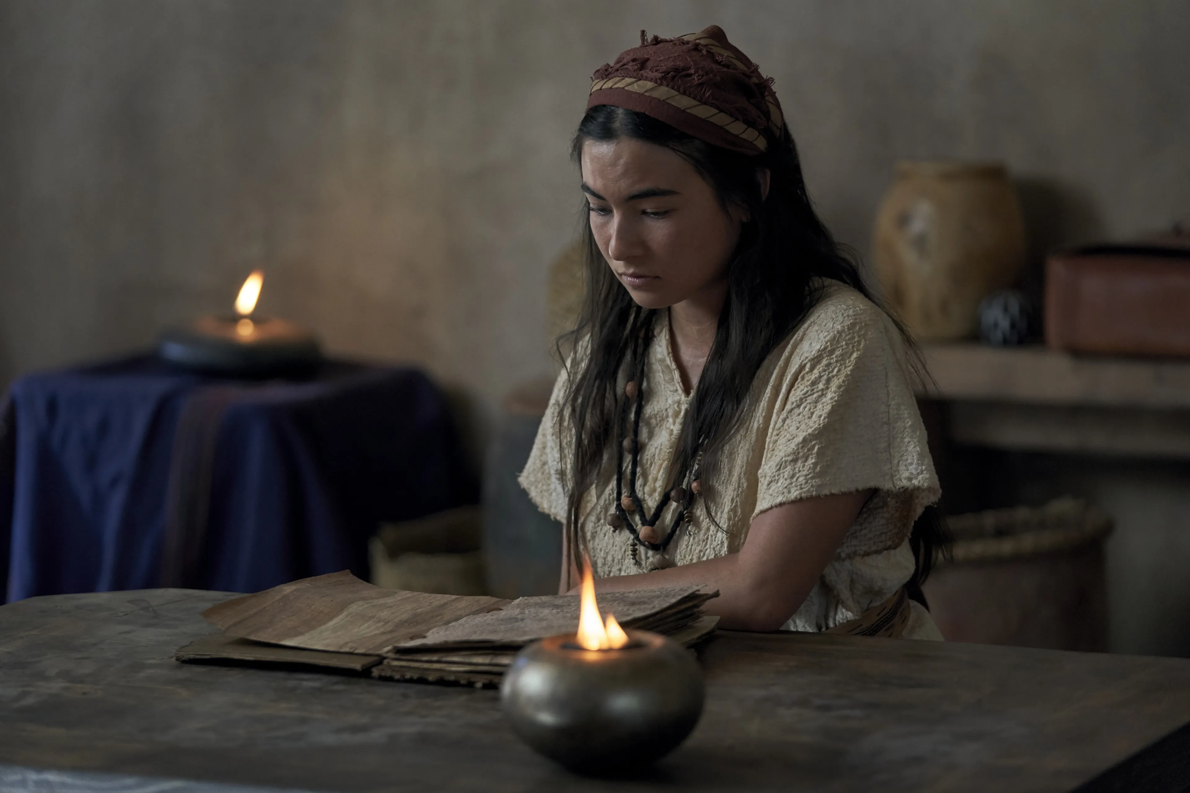 The wife of Enos reads at home.
