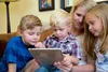 mother and children on tablet