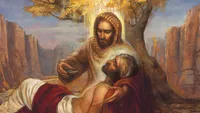 Painting of a Jesus helping a man who is lying on the road hurt. He is a Samaritan