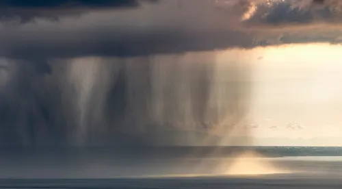 rain falling over the ocean