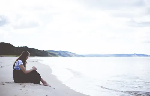 woman sitting on the beach