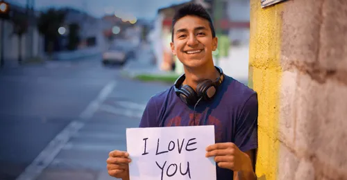 young man holding sign