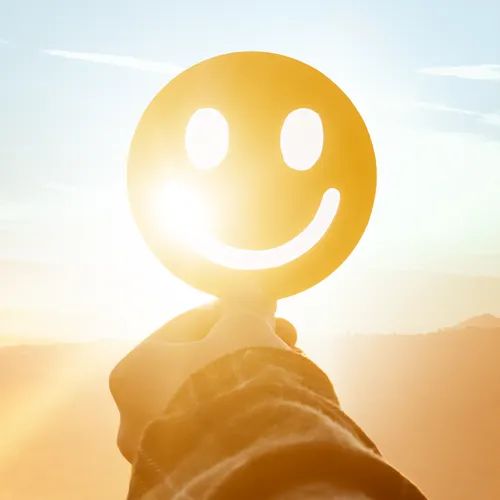 smiley face cutout against the sun