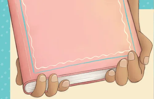 Hands holding a journal with a pink cover
