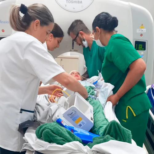 doctors with a boy on a hospital bed