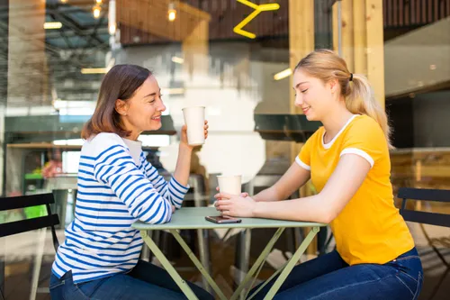 mother and daughter sitting at a café together