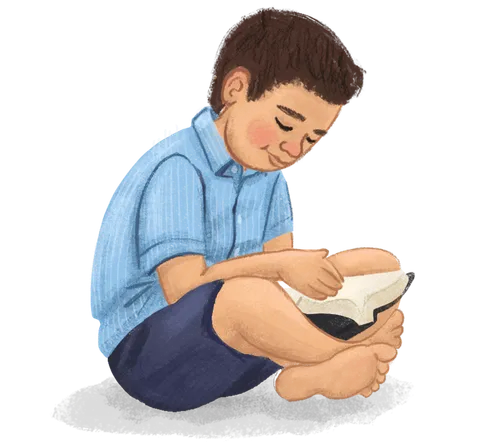 A boy sitting and reading a book
