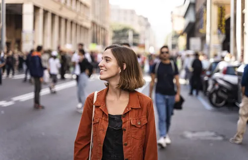 young adult woman walking along the street