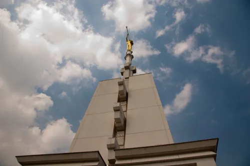 The angel Moroni statue is seen from a low angle atop the spire of the Mexico City Mexico Temple.