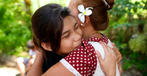 young woman embracing older woman