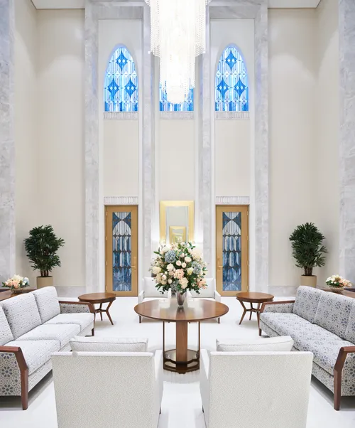 Interior image of the Brasilia Brazil Temple Celestial Room. Image features chairs around the room, the details of the carpet, and stained glass windows. 
