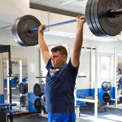 young man lifting weights