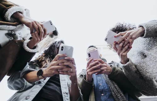 group of people looking at smartphones