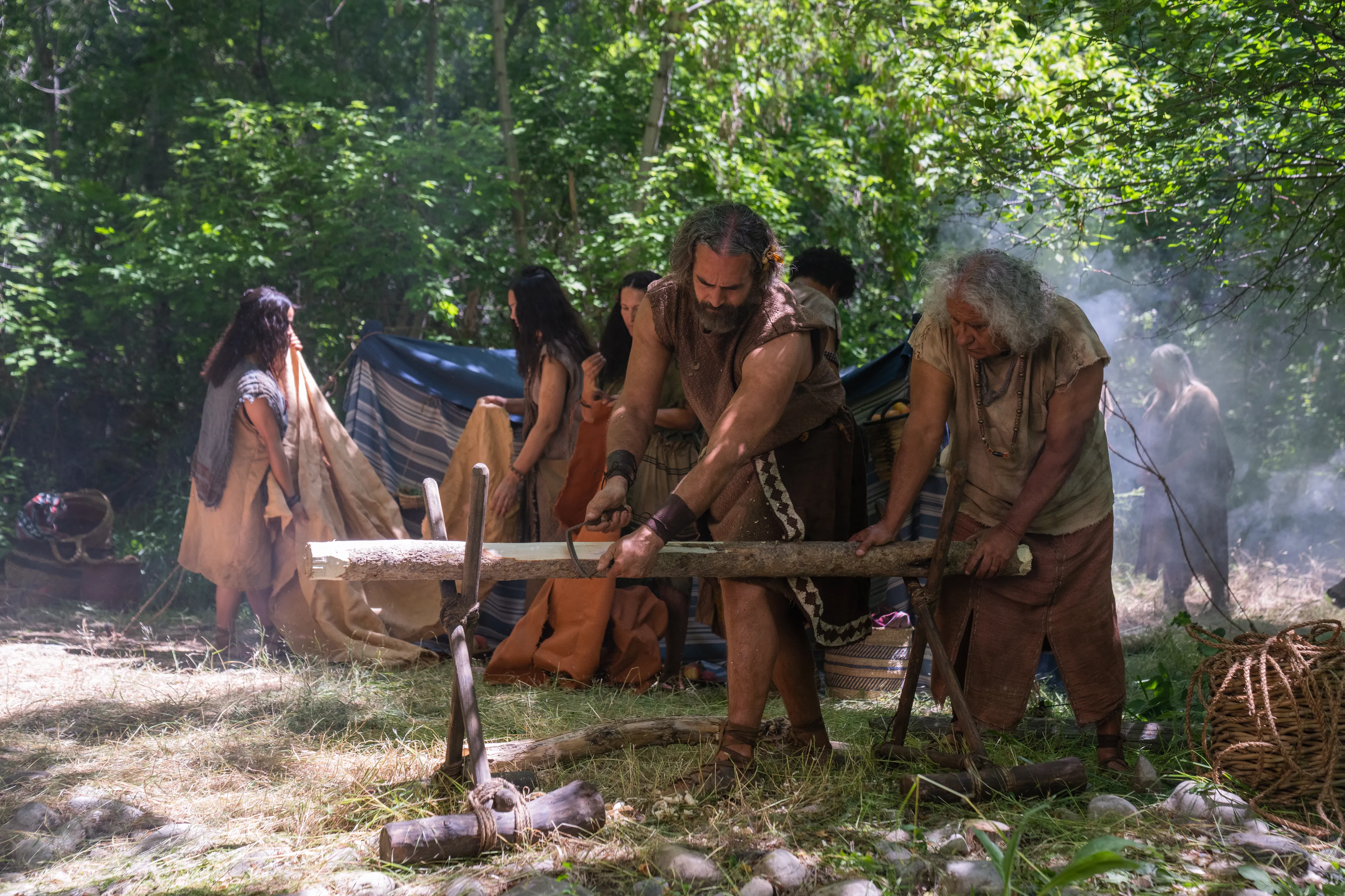 Helem helps cut a log after the people of Alma arrive at the Land of Helam and start to build.