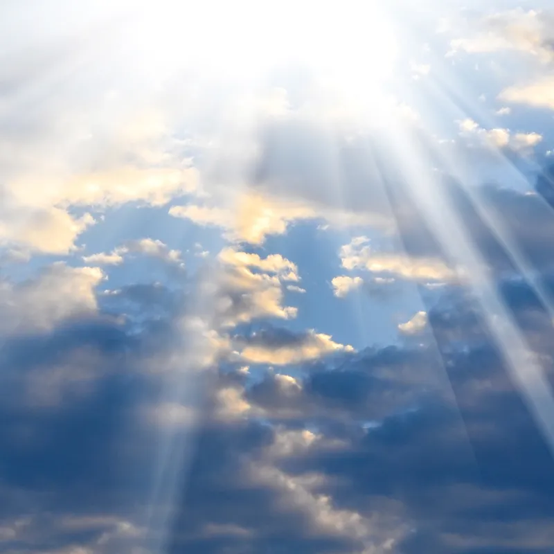 The sun shines through the clouds showing God's hand in all things