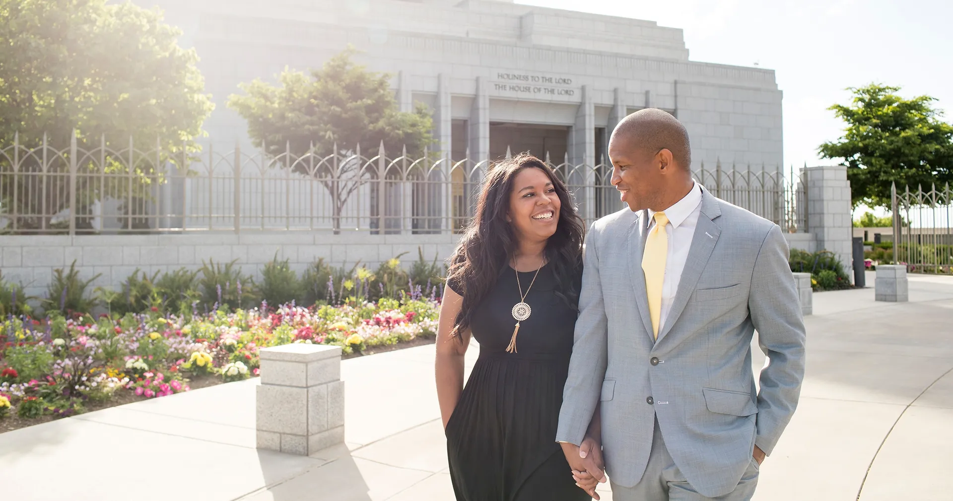 Couple walks past Draper Utah Temple