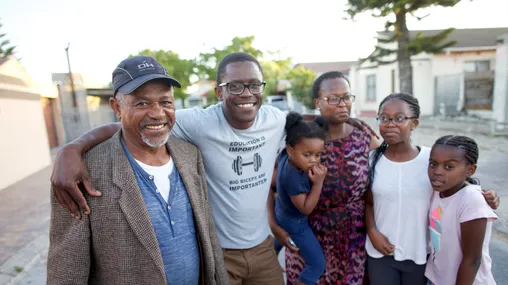 group of people smiling with arms around each other 