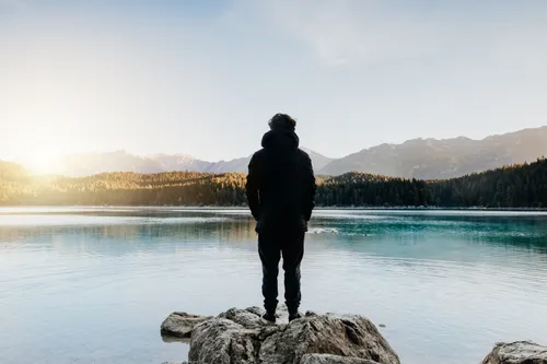 young man looking out at lake