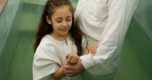 girl standing in baptismal font