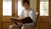 Young Joseph Smith sits in a chair reading the bible.