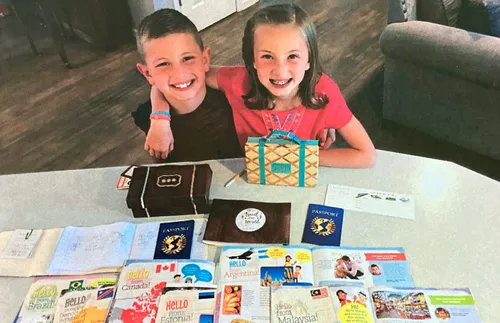 brother and sister showing copies of the Friend
