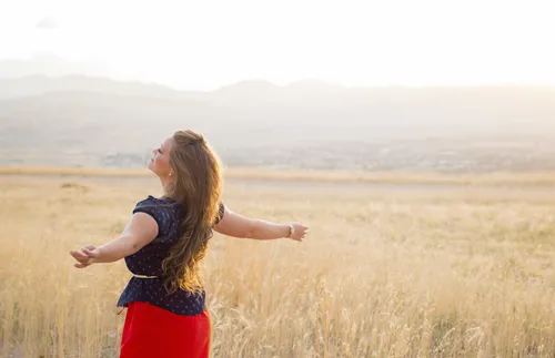 young adult woman standing in field