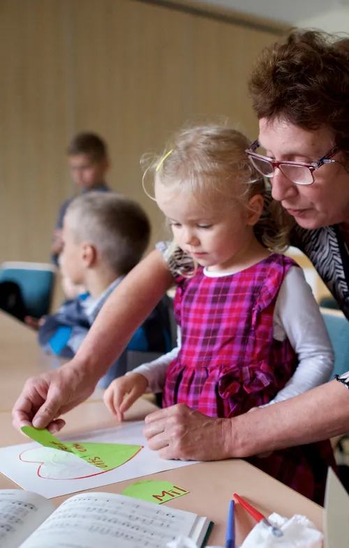 Primary teacher helping kid