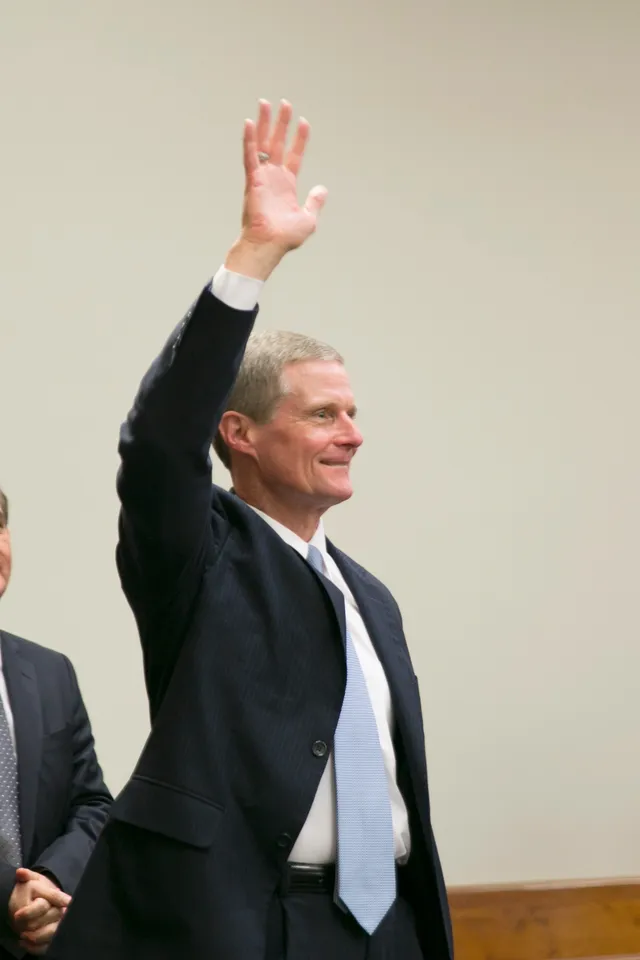 Elder David A. Bednar waving to people at a Priesthood Leader Training meeting in Lima, Peru in August 2015.