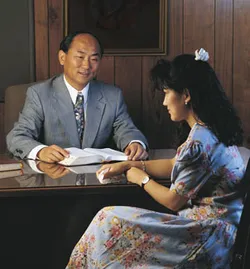 young woman and bishop at his desk