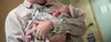 new baby in adult arms