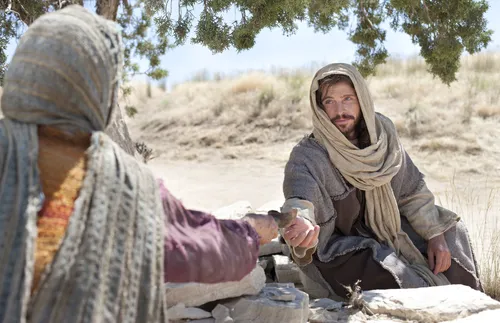 Jesus reaching out to receive a drink from the woman at the well.
