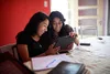 In this series of images young adult women and men meet together for an institute class in the instructors home. Many of the students are using smartphones and tablets to read from.