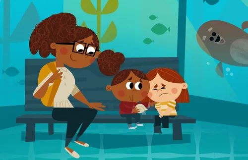 a mom with two girls sitting on bench at aquarium