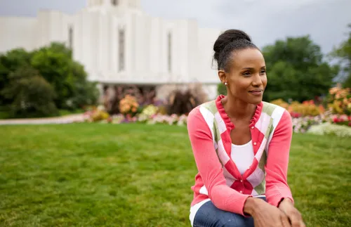 a woman sitting in front of the temple