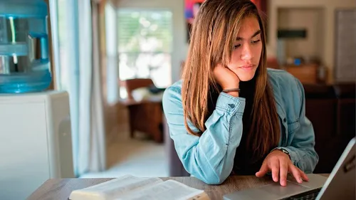 Youth studying on a computer