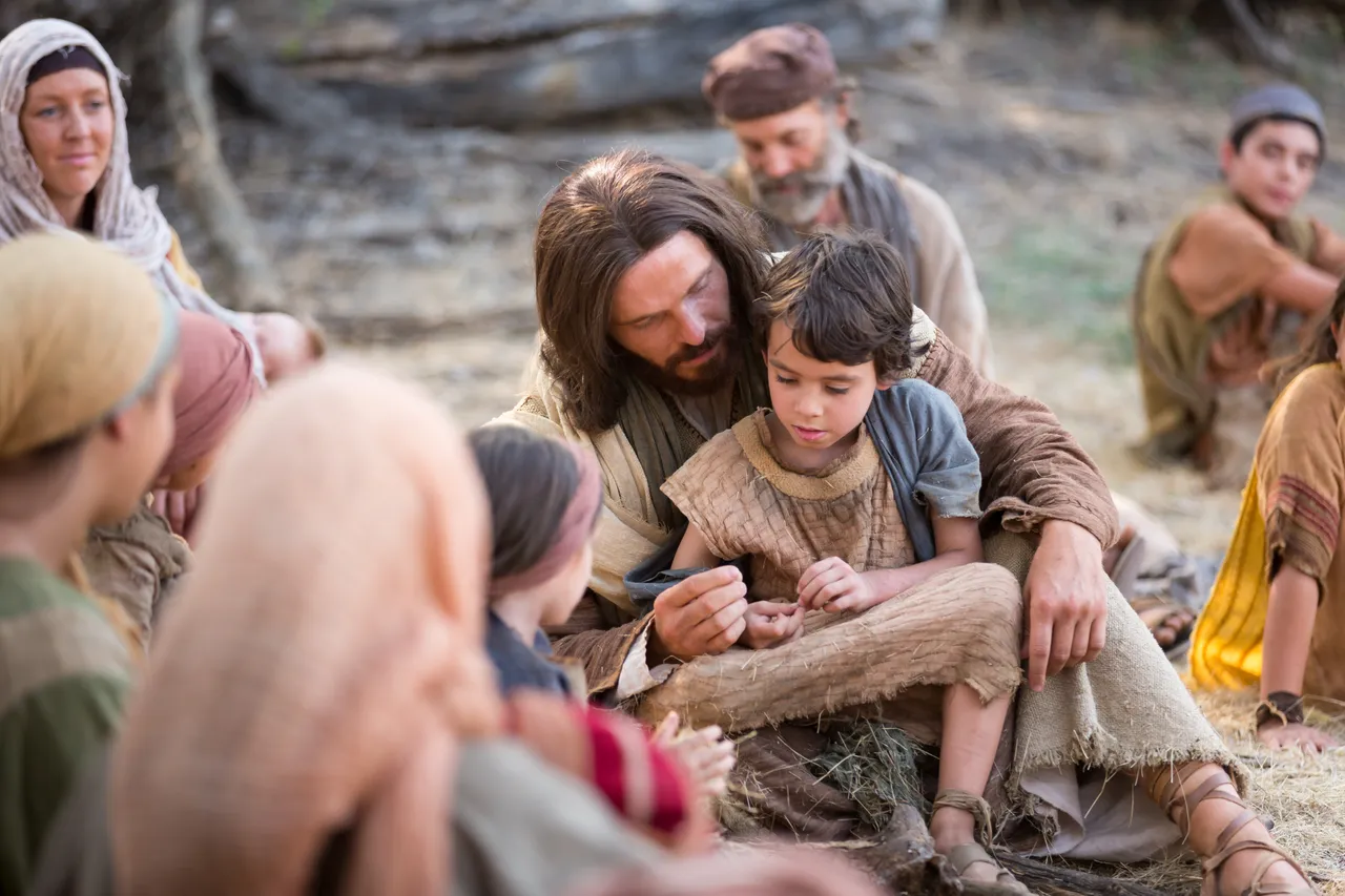 Jesus Christ with a child in his lap teaches that all must become as little children