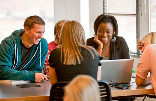 various young adults seated at a table