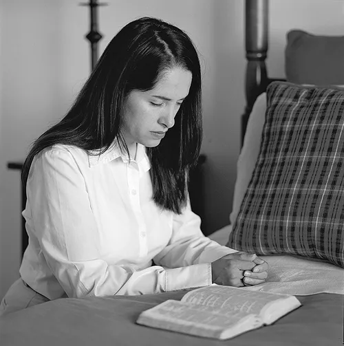 Woman kneeling in prayer