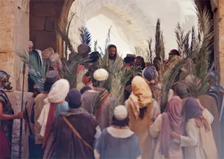 crowd around Jesus on donkey