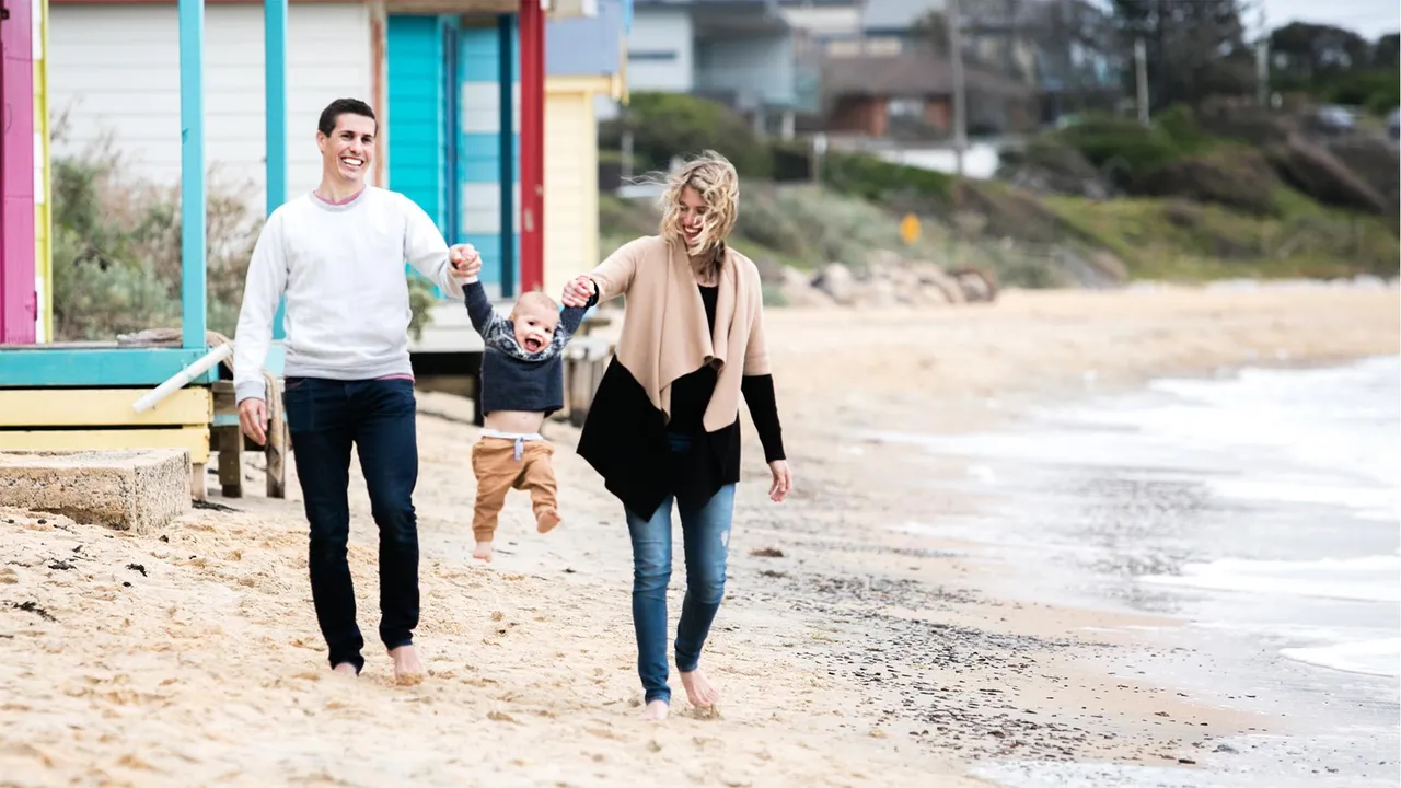 Steve and Whitney sit with their young child on the beach explain the blessings of the Book of Mormon